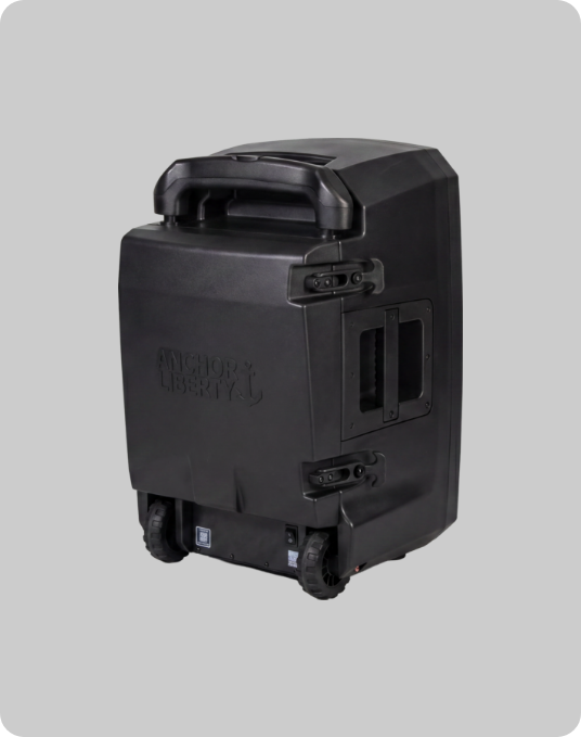Rear view of the Anchor Audio Liberty 3 portable PA speaker, showing built-in wheels, retractable pull handle, and rear panel hardware on a light gray background.